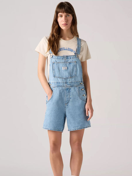 Levi's 523330059 Womens Vintage Shortalls Light Blue front view on model. If you need any assistance with this item or the purchase of this item please call us at five six one seven four eight eight eight zero one Monday through Saturday 10:00a.m EST to 8:00 p.m EST
