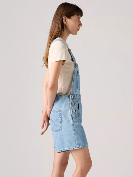 Levi's 523330059 Womens Vintage Shortalls Light Blue side view on model. If you need any assistance with this item or the purchase of this item please call us at five six one seven four eight eight eight zero one Monday through Saturday 10:00a.m EST to 8:00 p.m EST
