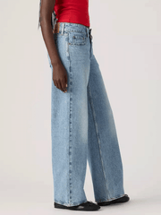 Levi's A74980019 Womens Superlow Loose Jeans Twisted Vibe Light Blue side view. If you need any assistance with this item or the purchase of this item please call us at five six one seven four eight eight eight zero one Monday through Saturday 10:00a.m EST to 8:00 p.m EST