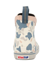A single XtratuF ankle boot shown from the back on a white background, featuring a blue, gray, and pink camouflage pattern on a cream base, with a blue pull tab and a gray sole. If you need any assistance with this item or the purchase of this item please call us at five six one seven four eight eight eight zero one Monday through Saturday 10:00a.m EST to 8:00 p.m EST