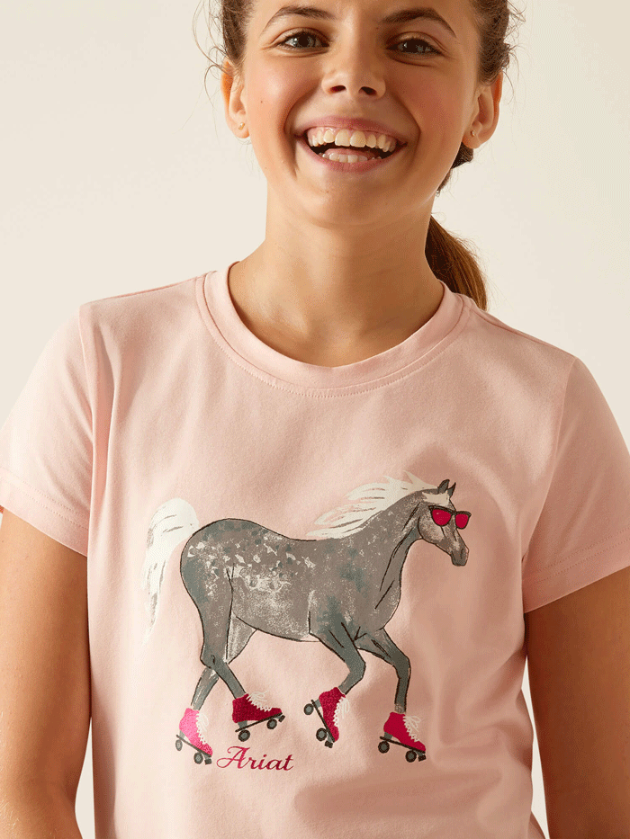 Ariat 10048554 Kids Roller Pony T-Shirt Blushing Rose front view. If you need any assistance with this item or the purchase of this item please call us at five six one seven four eight eight eight zero one Monday through Saturday 10:00a.m EST to 8:00 p.m EST