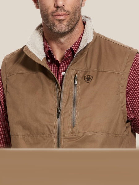 Ariat 10028416 Mens Grizzly Canvas Vest Cub Tan close up. If you need any assistance with this item or the purchase of this item please call us at five six one seven four eight eight eight zero one Monday through Saturday 10:00a.m EST to 8:00 p.m EST