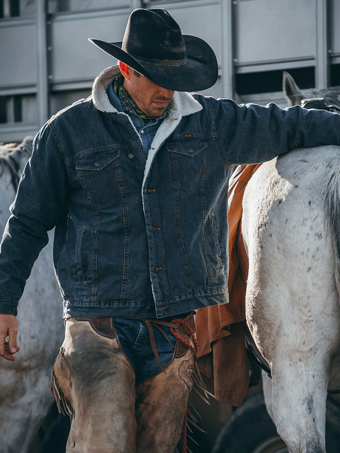 Wrangler 74256RT Mens Western Sherpa Lined Denim Trucker Jacket Rustic front view on model. If you need any assistance with this item or the purchase of this item please call us at five six one seven four eight eight eight zero one Monday through Saturday 10:00a.m EST to 8:00 p.m EST