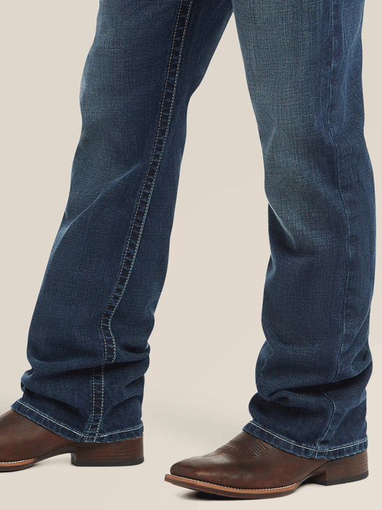 Ariat 10021767 Mens M4 Low Rise Adkins Boot Cut Jean Turnout leg view. If you need any assistance with this item or the purchase of this item please call us at five six one seven four eight eight eight zero one Monday through Saturday 10:00a.m EST to 8:00 p.m EST