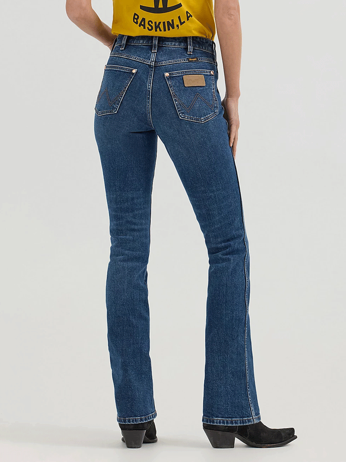 Wrangler 112360614 Womens X Lainey Wilson Boot Hugger Jeans Baskin Blue Wash front. If you need any assistance with this item or the purchase of this item please call us at five six one seven four eight eight eight zero one Monday through Saturday 10:00a.m EST to 8:00 p.m EST