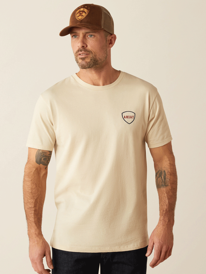 Ariat 10054001 Mens Barbed Flag T-Shirt Natural back. If you need any assistance with this item or the purchase of this item please call us at five six one seven four eight eight eight zero one Monday through Saturday 10:00a.m EST to 8:00 p.m EST