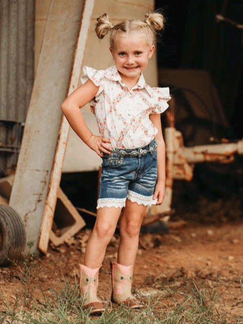 Shea Baby WRSB10 Kids Floral Boot Onesie Shirt With Fringe White front view infant model. If you need any assistance with this item or the purchase of this item please call us at five six one seven four eight eight eight zero one Monday through Saturday 10:00a.m EST to 8:00 p.m EST
