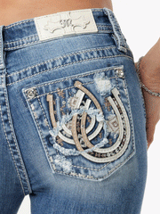 Miss Me M9303B Womens Horseshoe Bootcut Jean Neutral Blues back pocket close up view. If you need any assistance with this item or the purchase of this item please call us at five six one seven four eight eight eight zero one Monday through Saturday 10:00a.m EST to 8:00 p.m EST