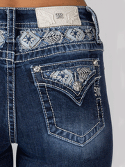 Miss Me M9195B Womens Mid-Rise Boot Jean Dark Blue back pocket close up. If you need any assistance with this item or the purchase of this item please call us at five six one seven four eight eight eight zero one Monday through Saturday 10:00a.m EST to 8:00 p.m EST