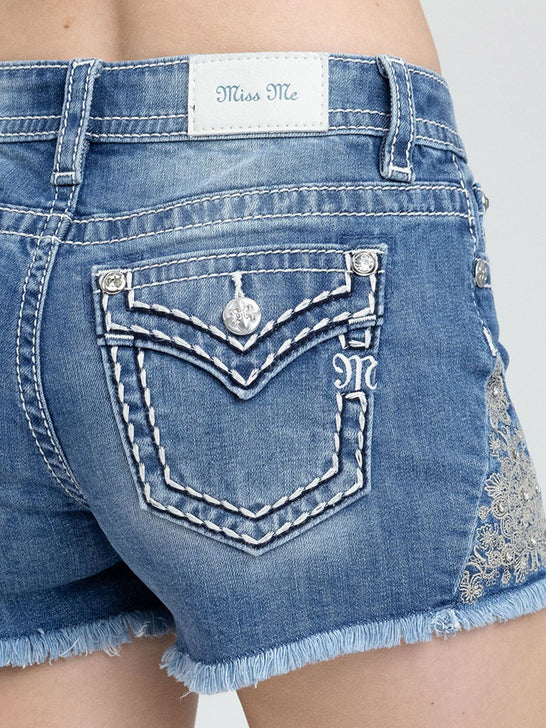 Miss Me M9660H Womens Mid-Rise Short Medium Wash Blue close up. If you need any assistance with this item or the purchase of this item please call us at five six one seven four eight eight eight zero one Monday through Saturday 10:00a.m EST to 8:00 p.m EST