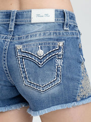 Miss Me M9660H Womens Mid-Rise Short Medium Wash Blue close up. If you need any assistance with this item or the purchase of this item please call us at five six one seven four eight eight eight zero one Monday through Saturday 10:00a.m EST to 8:00 p.m EST