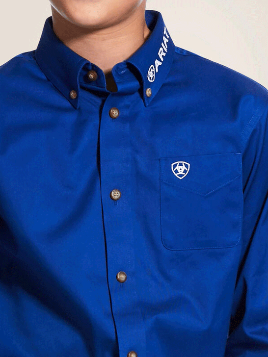 Ariat 10030164 Kids Team Logo Twill Classic Fit Shirt Ultramarine Blue front close up view of pocket and collar. If you need any assistance with this item or the purchase of this item please call us at five six one seven four eight eight eight zero one Monday through Saturday 10:00a.m EST to 8:00 p.m EST