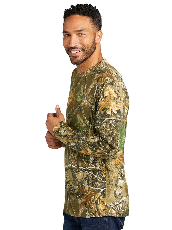 Russell Outdoors RU100LSP Mens Long Sleeve Pocket Tee Realtree Edge front view. If you need any assistance with this item or the purchase of this item please call us at five six one seven four eight eight eight zero one Monday through Saturday 10:00a.m EST to 8:00 p.m EST