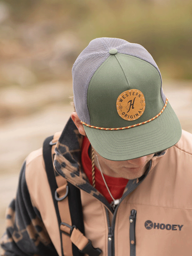 Hooey 2314T-OLGY SPUR High Profile Snapback Trucker Hat Olive And Grey front and side view. If you need any assistance with this item or the purchase of this item please call us at five six one seven four eight eight eight zero one Monday through Saturday 10:00a.m EST to 8:00 p.m EST

