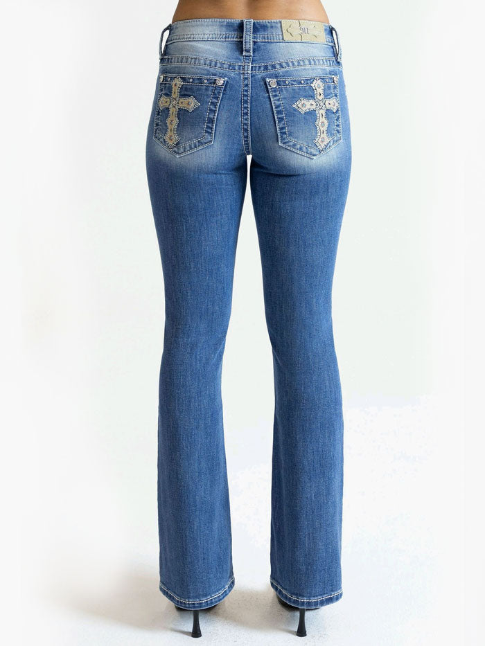 Miss Me M9358BV Womens Cross Mid Rise Boot Jean Medium Blue close up. If you need any assistance with this item or the purchase of this item please call us at five six one seven four eight eight eight zero one Monday through Saturday 10:00a.m EST to 8:00 p.m EST