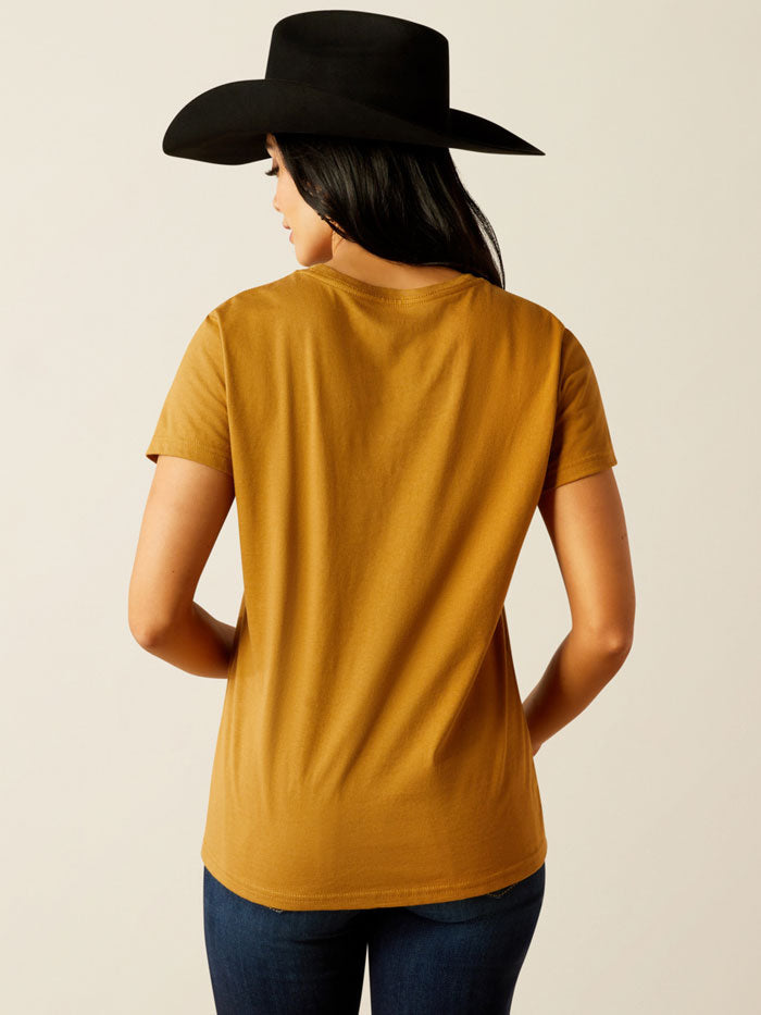 Ariat 10054035 Womens Stay Gold T-Shirt Harvest Gold front view. If you need any assistance with this item or the purchase of this item please call us at five six one seven four eight eight eight zero one Monday through Saturday 10:00a.m EST to 8:00 p.m EST