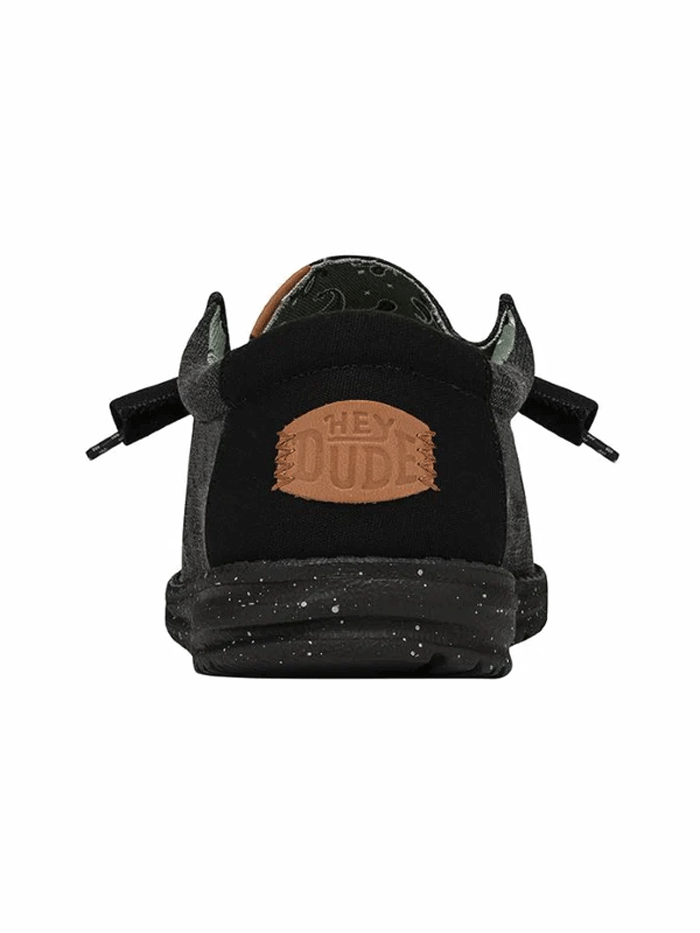 Hey Dude 40296-060 Mens Wally Washed Canvas Shoe Black front and side view. If you need any assistance with this item or the purchase of this item please call us at five six one seven four eight eight eight zero one Monday through Saturday 10:00a.m EST to 8:00 p.m EST
