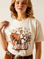 Ariat 10047924 Womens Let's Rodeo T-Shirt Off White close up view  of front. If you need any assistance with this item or the purchase of this item please call us at five six one seven four eight eight eight zero one Monday through Saturday 10:00a.m EST to 8:00 p.m EST