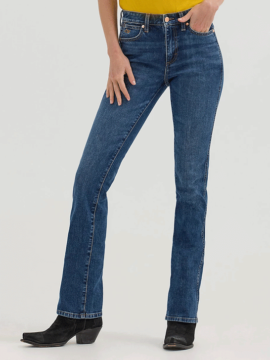 Wrangler 112360614 Womens X Lainey Wilson Boot Hugger Jeans Baskin Blue Wash front. If you need any assistance with this item or the purchase of this item please call us at five six one seven four eight eight eight zero one Monday through Saturday 10:00a.m EST to 8:00 p.m EST