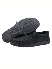 Hey Dude 150204942 Mens Wally Sox Micro Total Black sole and side view. If you need any assistance with this item or the purchase of this item please call us at five six one seven four eight eight eight zero one Monday through Saturday 10:00a.m EST to 8:00 p.m EST