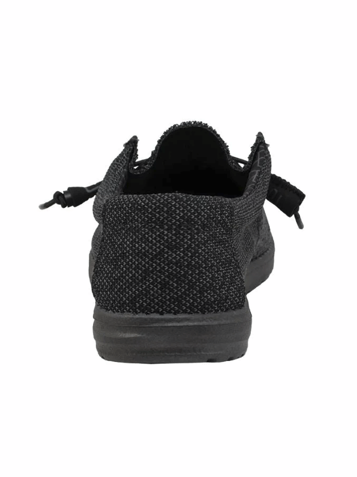 Hey Dude 150204942 Mens Wally Sox Micro Total Black front and side view. If you need any assistance with this item or the purchase of this item please call us at five six one seven four eight eight eight zero one Monday through Saturday 10:00a.m EST to 8:00 p.m EST