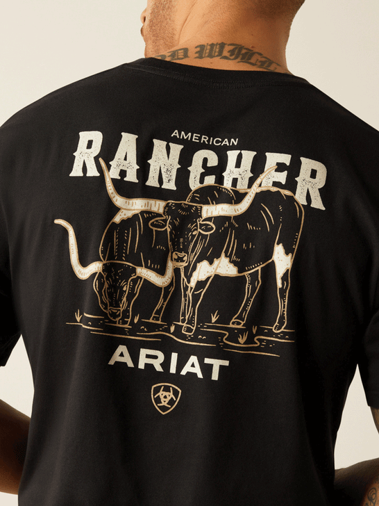 Ariat 10052018 Mens American Rancher T-Shirt Black back graphic close up view. If you need any assistance with this item or the purchase of this item please call us at five six one seven four eight eight eight zero one Monday through Saturday 10:00a.m EST to 8:00 p.m EST