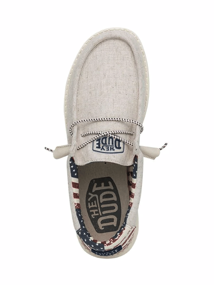 Hey Dude 40001-1K1 Mens Wally Patriotic Shoe Off White front and side view. If you need any assistance with this item or the purchase of this item please call us at five six one seven four eight eight eight zero one Monday through Saturday 10:00a.m EST to 8:00 p.m EST