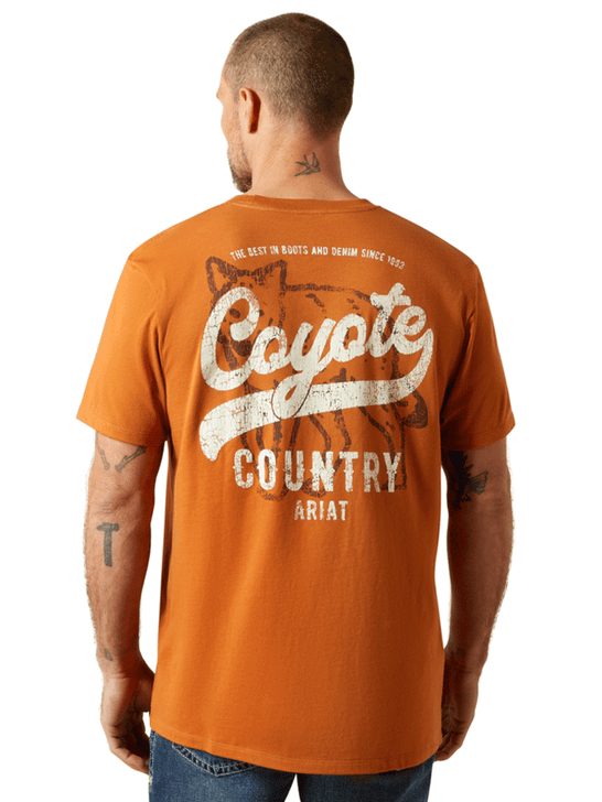 Ariat 10065902 Mens Coyote Country T-Shirt Adobe Copper back view. If you need any assistance with this item or the purchase of this item please call us at five six one seven four eight eight eight zero one Monday through Saturday 10:00a.m EST to 8:00 p.m EST