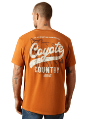 Ariat 10065902 Mens Coyote Country T-Shirt Adobe Copper back view. If you need any assistance with this item or the purchase of this item please call us at five six one seven four eight eight eight zero one Monday through Saturday 10:00a.m EST to 8:00 p.m EST