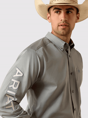 Ariat 10071690 Mens Team Logo Lightweight Twill Fitted Shirt Grey arm close up view. If you need any assistance with this item or the purchase of this item please call us at five six one seven four eight eight eight zero one Monday through Saturday 10:00a.m EST to 8:00 p.m EST