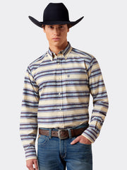 A man wearing a long-sleeve western button-down shirt with beige, blue, and brown horizontal stripes, paired with blue jeans, a brown leather belt, and a black cowboy hat, against a light gray studio background. If you need any assistance with this item or the purchase of this item please call us at five six one seven four eight eight eight zero one Monday through Saturday 10:00a.m EST to 8:00 p.m EST