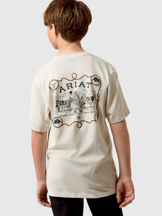 A child model shown from the back wearing a cream-colored t-shirt with a large brown graphic print on the back featuring the brand name 'Ariat' and western-themed illustrations. If you need any assistance with this item or the purchase of this item please call us at five six one seven four eight eight eight zero one Monday through Saturday 10:00a.m EST to 8:00 p.m EST