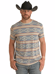 Rock & Roll Denim BU21T03021 Unisex All Over Aztec Print Tee Light Blue front view on male model. If you need any assistance with this item or the purchase of this item please call us at five six one seven four eight eight eight zero one Monday through Saturday 10:00a.m EST to 8:00 p.m EST