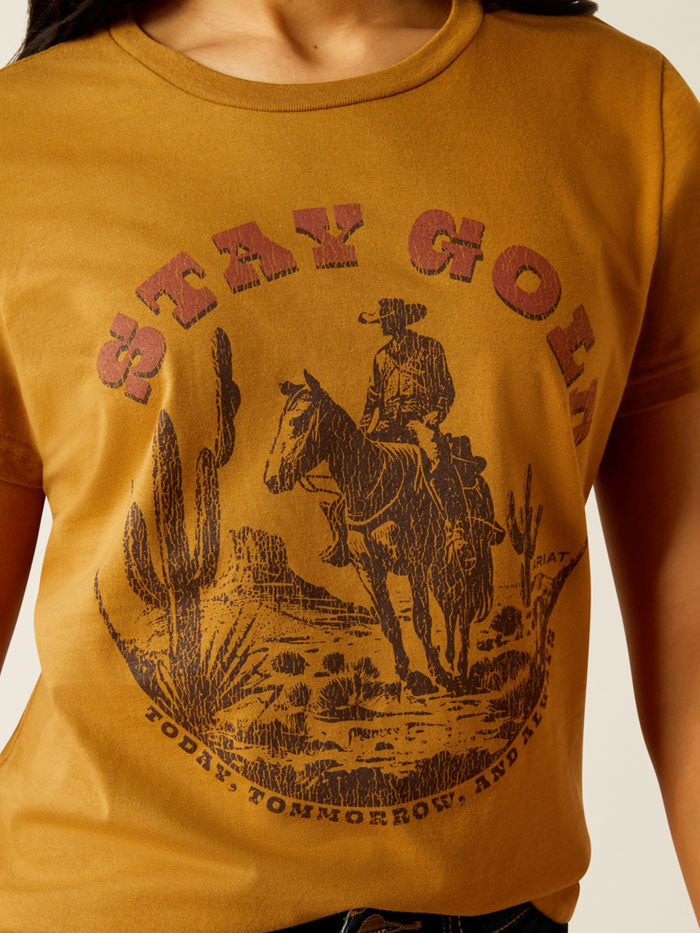 Ariat 10054035 Womens Stay Gold T-Shirt Harvest Gold front view. If you need any assistance with this item or the purchase of this item please call us at five six one seven four eight eight eight zero one Monday through Saturday 10:00a.m EST to 8:00 p.m EST