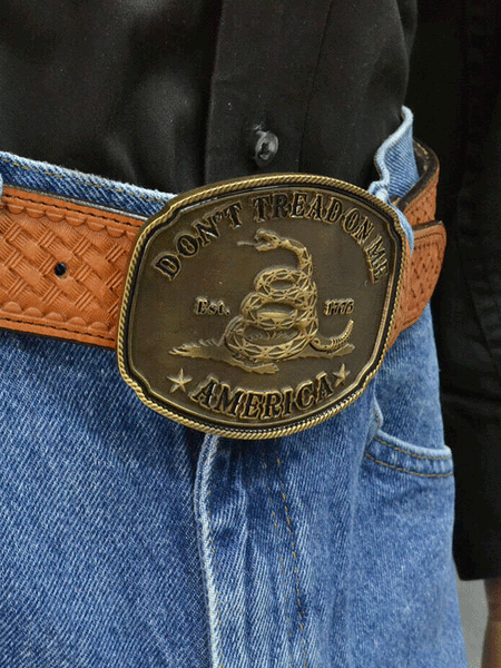 Montana Silversmiths A515C American Gadsden Don't Tread on Me Heritage Attitude Buckle Bronze front view on a model. If you need any assistance with this item or the purchase of this item please call us at five six one seven four eight eight eight zero one Monday through Saturday 10:00a.m EST to 8:00 p.m EST