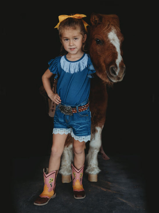 Shea Baby SBD02 Kids Denim Lace Shorts Blue front view on model. If you need any assistance with this item or the purchase of this item please call us at five six one seven four eight eight eight zero one Monday through Saturday 10:00a.m EST to 8:00 p.m EST