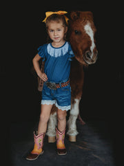 Shea Baby SBD02 Kids Denim Lace Shorts Blue front view on model. If you need any assistance with this item or the purchase of this item please call us at five six one seven four eight eight eight zero one Monday through Saturday 10:00a.m EST to 8:00 p.m EST