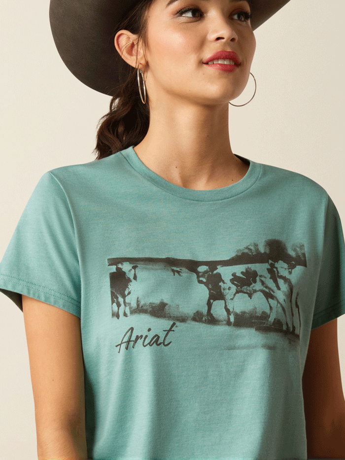 Ariat 10052546 Womens Wholesome Heffers Tee Ocean Blue Heather front view. If you need any assistance with this item or the purchase of this item please call us at five six one seven four eight eight eight zero one Monday through Saturday 10:00a.m EST to 8:00 p.m EST