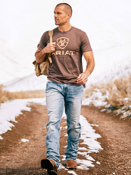 Ariat 10027515 Mens Liberty USA T-Shirt Brown Heather alternate front view on model outdoors.If you need any assistance with this item or the purchase of this item please call us at five six one seven four eight eight eight zero one Monday through Saturday 10:00a.m EST to 8:00 p.m EST