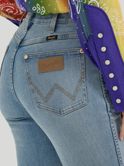 Wrangler 112360639 Womens X Lainey Wilson Raw Hem Boot Hugger Jeans Sky Wash back close up. If you need any assistance with this item or the purchase of this item please call us at five six one seven four eight eight eight zero one Monday through Saturday 10:00a.m EST to 8:00 p.m EST

