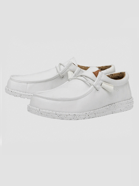 Hey Dude 40296-100 Mens Wally Washed Canvas Shoe White front and side view. If you need any assistance with this item or the purchase of this item please call us at five six one seven four eight eight eight zero one Monday through Saturday 10:00a.m EST to 8:00 p.m EST