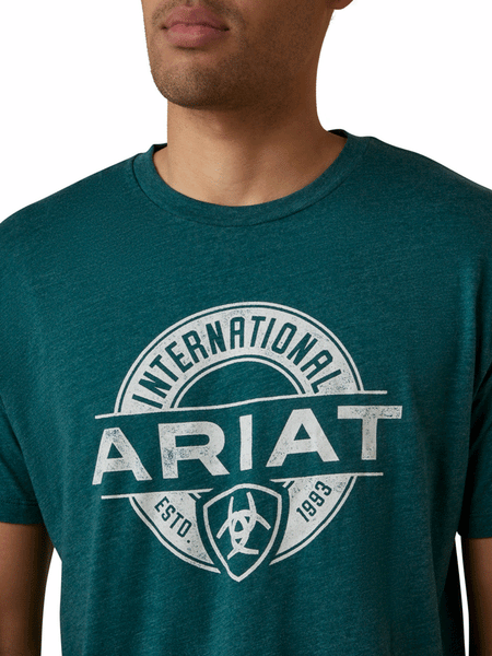 Ariat 10045284 Mens Center Fire T-Shirt Dark Teal Heather front close up view. If you need any assistance with this item or the purchase of this item please call us at five six one seven four eight eight eight zero one Monday through Saturday 10:00a.m EST to 8:00 p.m EST