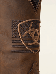 Ariat 10061326 Mens Sport Freeedom Cowboy Boot Distressed Brown logo close up. If you need any assistance with this item or the purchase of this item please call us at five six one seven four eight eight eight zero one Monday through Saturday 10:00a.m EST to 8:00 p.m EST