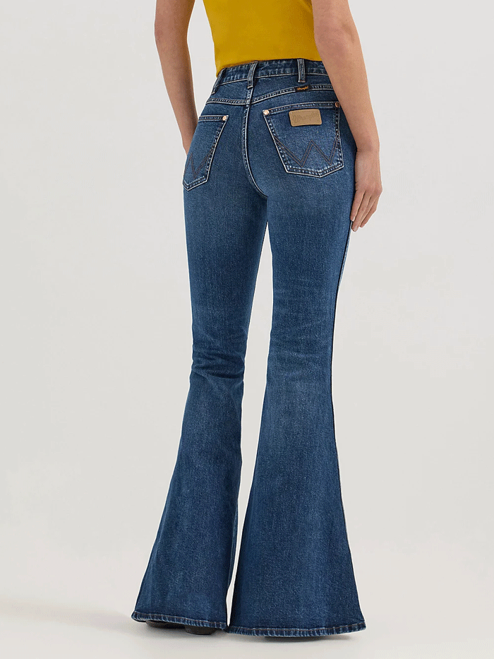 Wrangler 112360638 Womens X Lainey Wilson Bell Bottoms Jeans Baskin Blue Wash front. If you need any assistance with this item or the purchase of this item please call us at five six one seven four eight eight eight zero one Monday through Saturday 10:00a.m EST to 8:00 p.m EST

