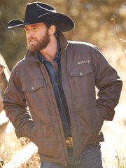 Ariat 10046385 Mens Grizzly 2.0 Canvas Conceal and Carry Jacket Bracken alternate front view on model outdoors. If you need any assistance with this item or the purchase of this item please call us at five six one seven four eight eight eight zero one Monday through Saturday 10:00a.m EST to 8:00 p.m EST