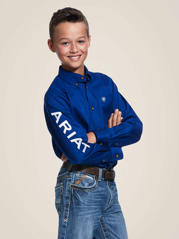 Ariat 10030164 Kids Team Logo Twill Classic Fit Shirt Ultramarine Blue front and side view arm embroidery detail. If you need any assistance with this item or the purchase of this item please call us at five six one seven four eight eight eight zero one Monday through Saturday 10:00a.m EST to 8:00 p.m EST