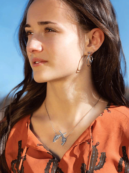 Montana Silversmiths NC5879 Womens Crossed Pistols Pendant Necklace Silver on model. If you need any assistance with this item or the purchase of this item please call us at five six one seven four eight eight eight zero one Monday through Saturday 10:00a.m EST to 8:00 p.m EST