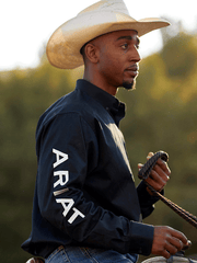 Ariat 10034231 Mens Team Logo Twill Fitted Shirt Black side view on model riding. If you need any assistance with this item or the purchase of this item please call us at five six one seven four eight eight eight zero one Monday through Saturday 10:00a.m EST to 8:00 p.m EST