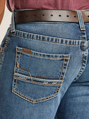 Ariat 10021879 Mens M5 Slim Stretch Stillwell Stackable Straight Leg Jean Fargo back pocket close up view. If you need any assistance with this item or the purchase of this item please call us at five six one seven four eight eight eight zero one Monday through Saturday 10:00a.m EST to 8:00 p.m EST