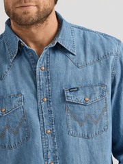 Wrangler 112361699 Mens Classic Denim Western Snap Shirt Light Wash front close up view. If you need any assistance with this item or the purchase of this item please call us at five six one seven four eight eight eight zero one Monday through Saturday 10:00a.m EST to 8:00 p.m EST